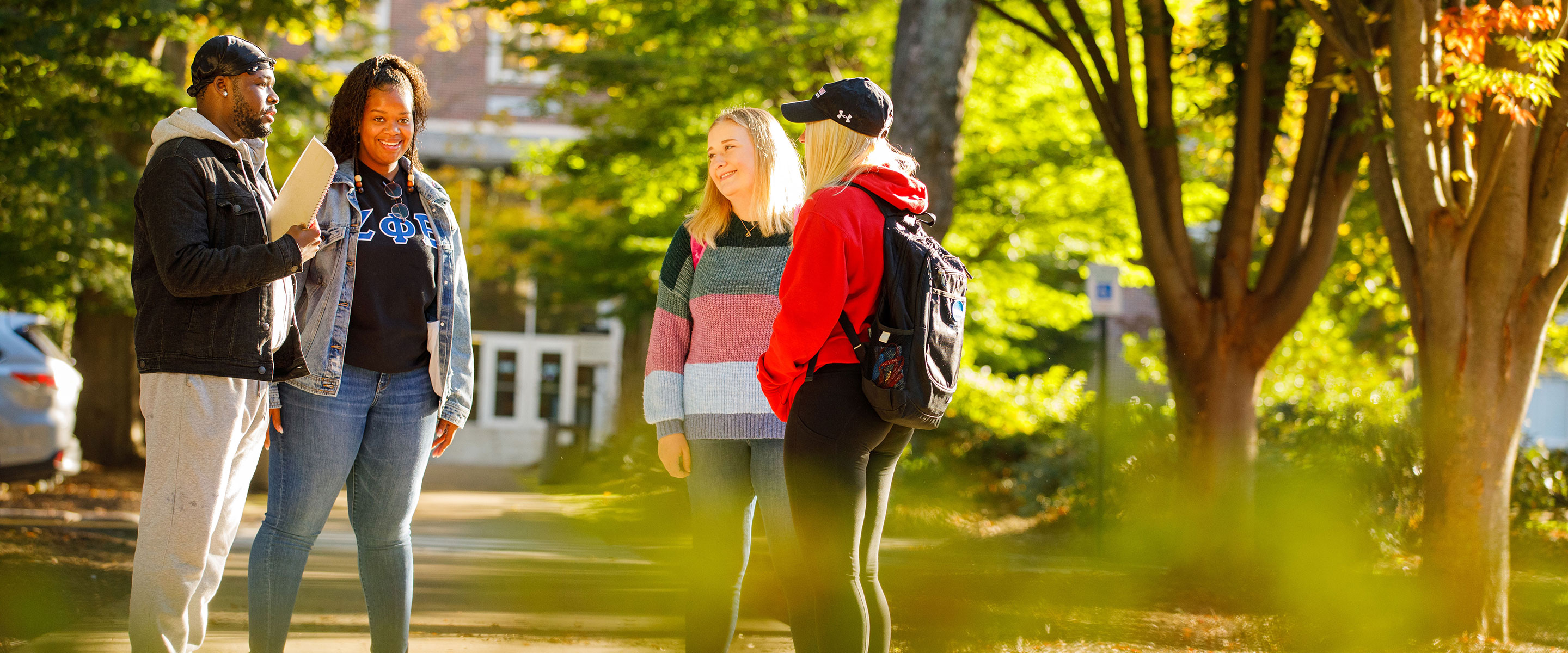 4 students standing in front of stroud hall