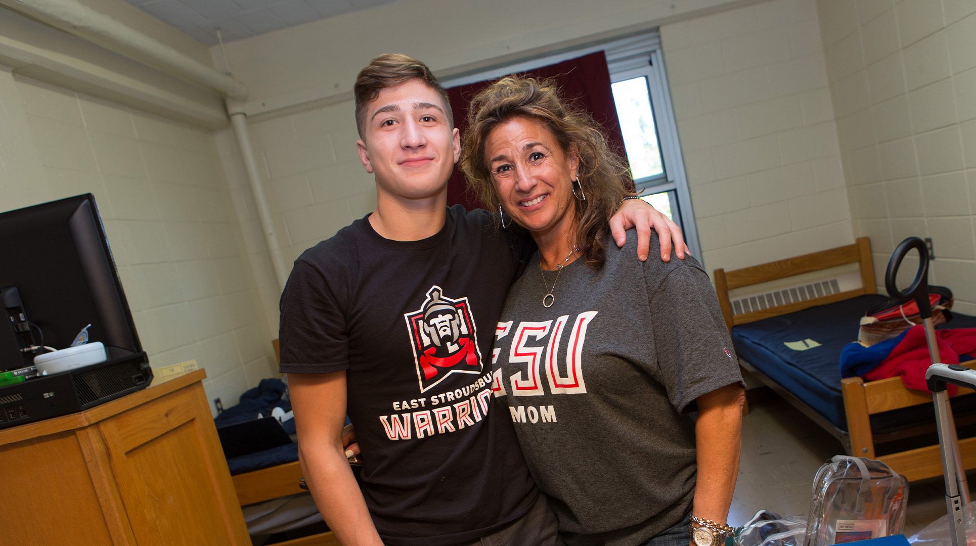 Mother and Son standing in son's dorm room