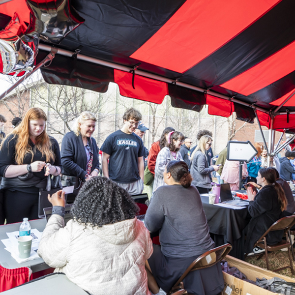 Students lined up at table