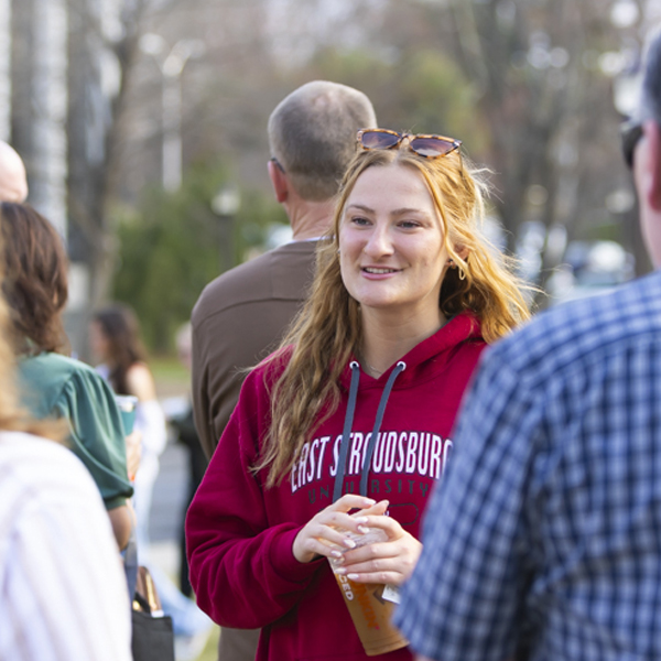 Student standing with ESU sweater