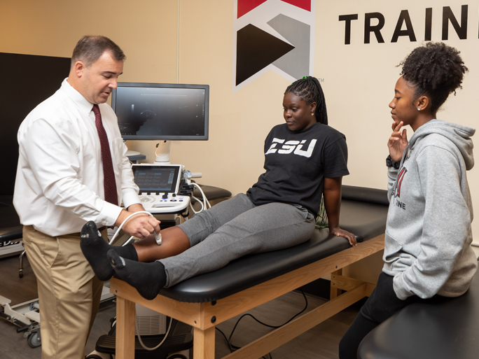 Gerard Rozea checking a student's injury