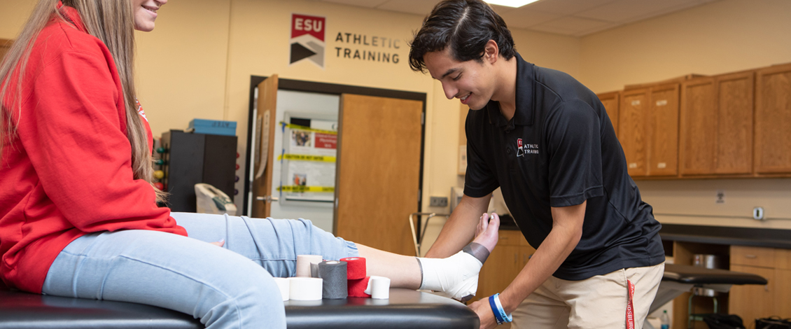 Gerard Rozea examining student's ankle