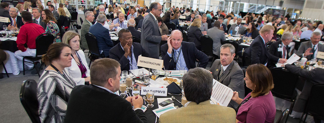 Attendees at a table discussing infrastructure at the 2018 Economic Outlook Summit